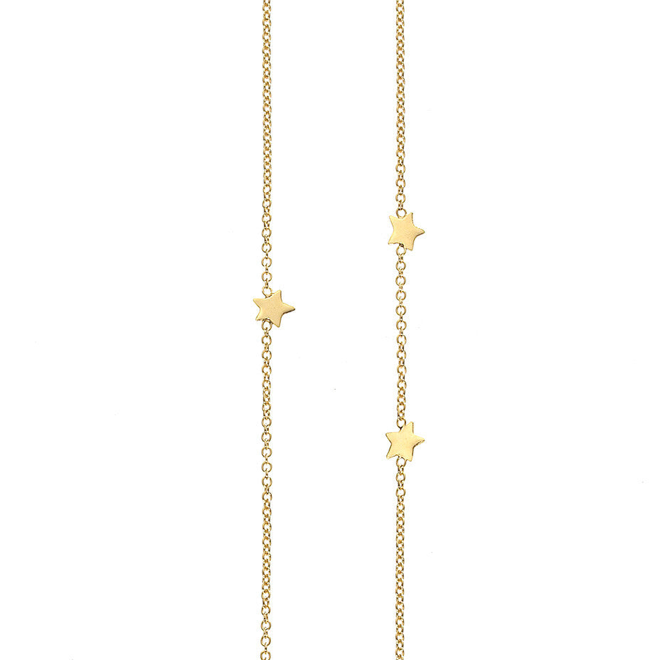 Eleven Star Long necklace in gold, featuring eleven shiny stars inserted into a chain in a random scatter to represent the night sky. 