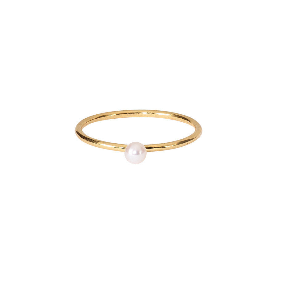 The Lunar Mini White Pearl ring in gold, featuring a freshwater pearl on a simple band.