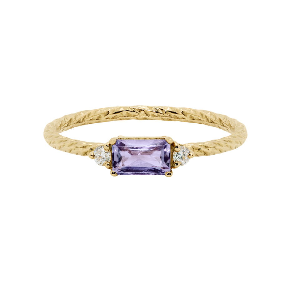 Amethyst trilogy birthstone ring with two white diamond side stones on a textured gold band.