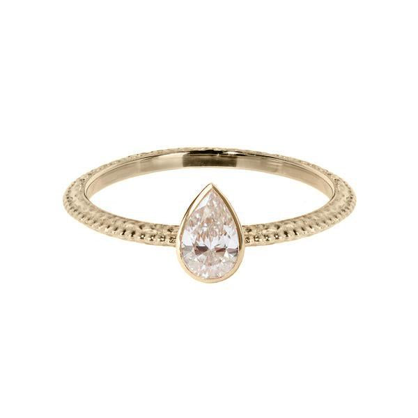 The Harmony engagement ring with a pear shaped white diamond which is bezel set. The textured band has a beautiful beaded line running down the centre. Made from 18 carat yellow gold. 