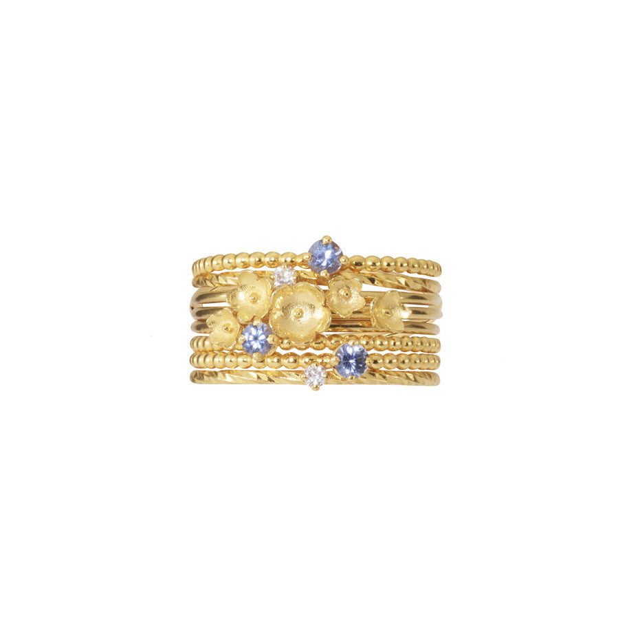 Nature Lover Stacking set in gold, featuring little flowers, white diamonds and blue sapphires.