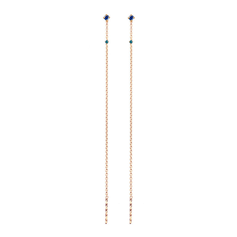 A combination of a royal blue sapphire and a teal diamond on thread through rose gold earrings.