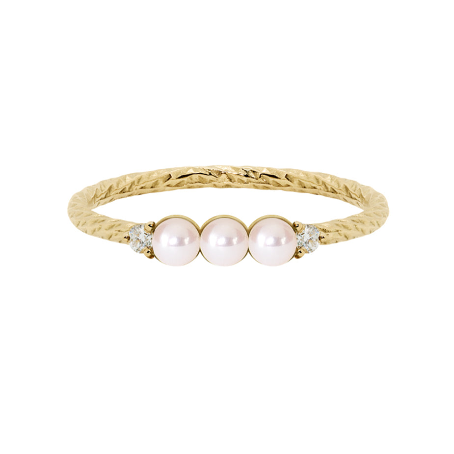 Pearl five stone birthstone ring with two white diamond side stones on a textured gold band.