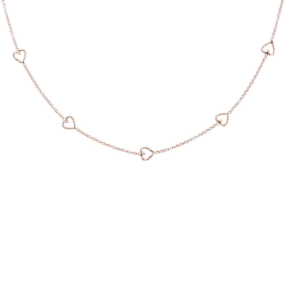 The Loop Of Love necklace in rose gold, featuring 5 tiny open hearts.