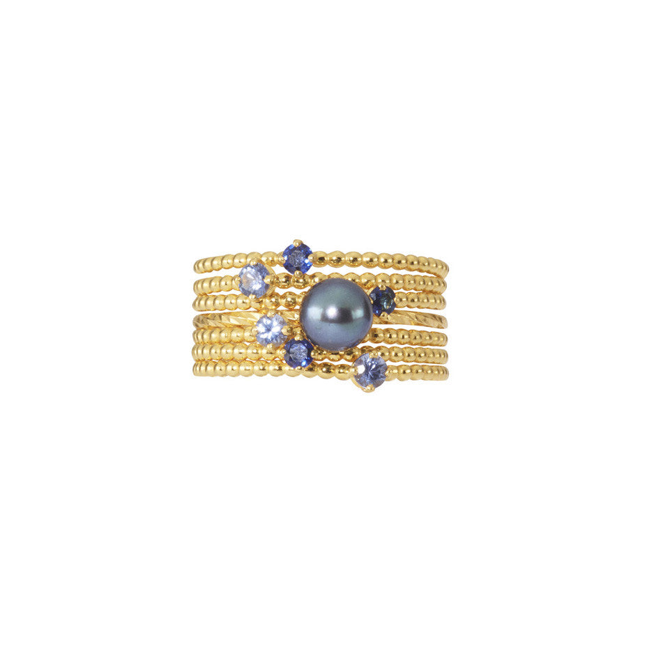 Midnight Stacking Set in gold, combining 3 Forget-Me-Not Blue sapphire rings and 3 Royal Blue sapphire rings together with a Pirate's Black Pearl ring.