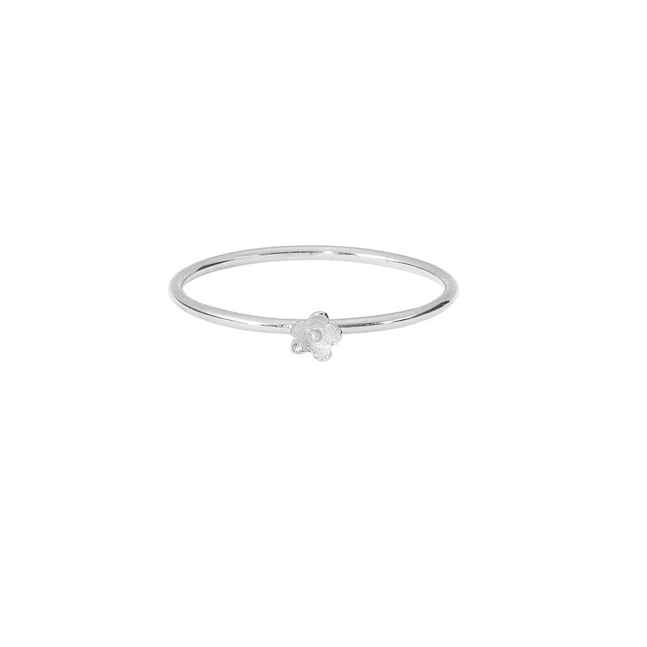 Flower Stacking ring in silver, featuring a smooth band and the prettiest little flower.
