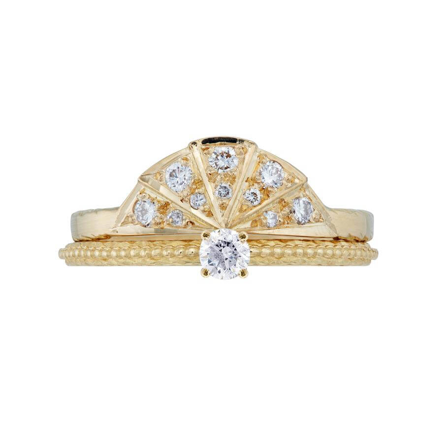 The white diamond solitaire Tender Love engagement ring in 18 carat yellow gold, combined with the white diamond Sunbeam wedding band.