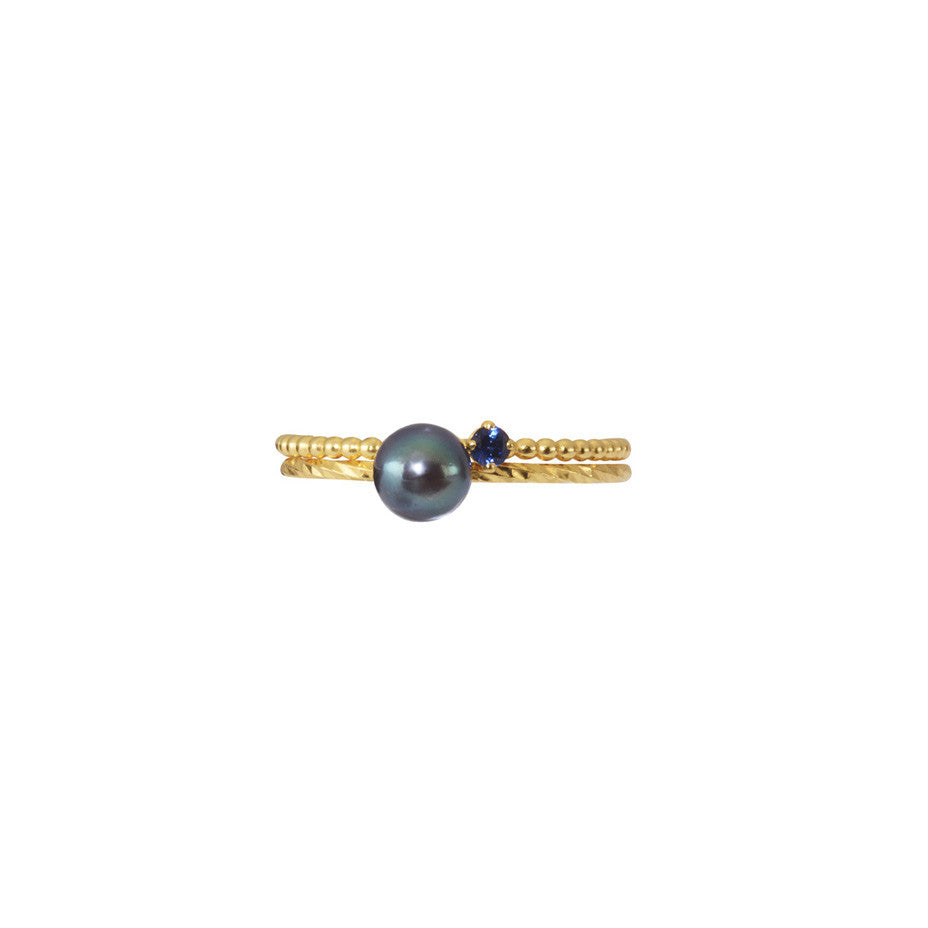 A combination of our signature multi faceted and beaded stacking rings adorned with Pirate's Black Pearl and Royal Blue sapphire.