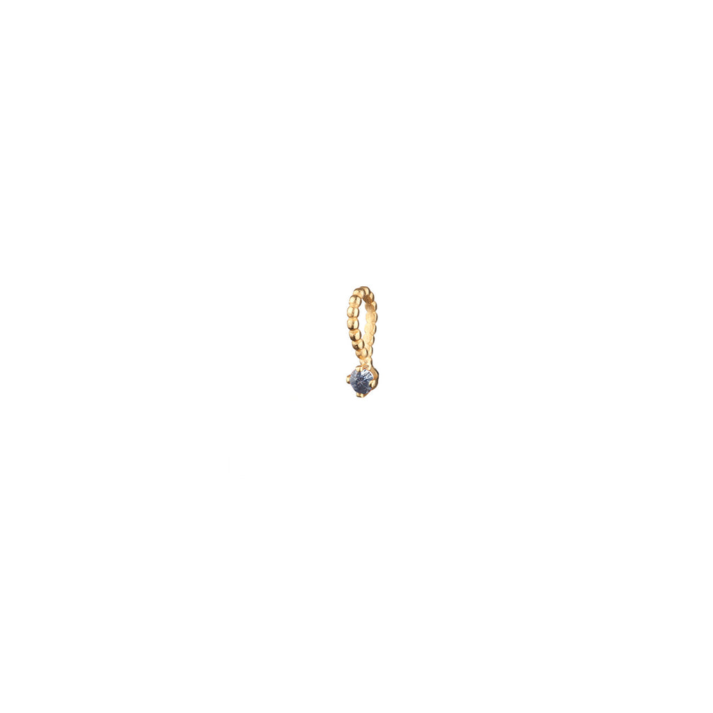 Light blue sapphire charm with beaded bail in gold.