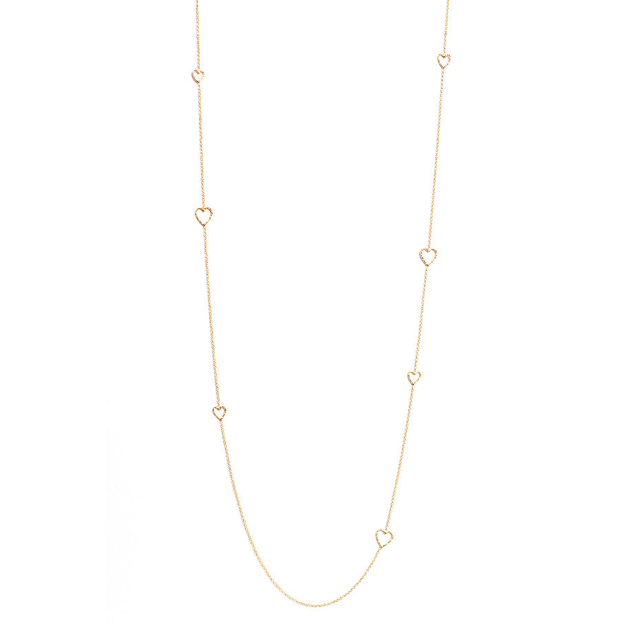 Follow Your Heart Long necklace in gold, featuring textured cut out hearts inserted into a delicate chain.