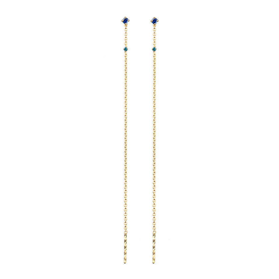 A combination of a royal blue sapphire and a teal diamond on thread through gold earrings.