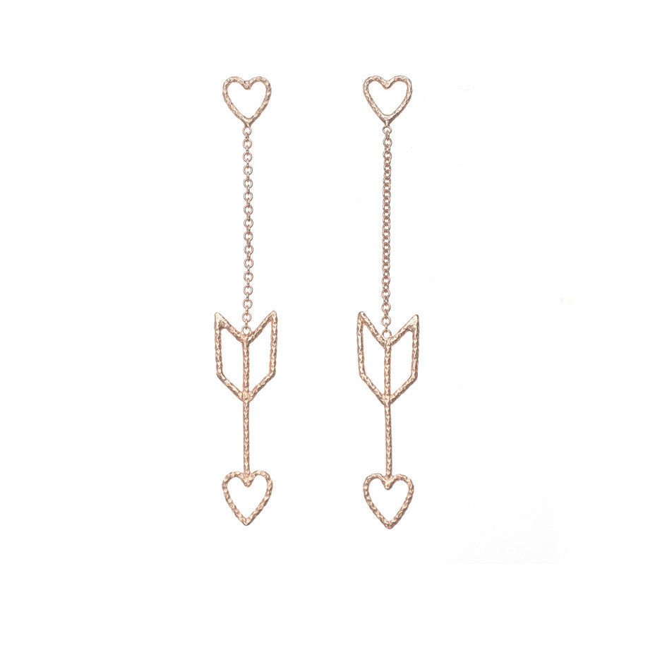 Arrow Of Love earrings in rose gold. The heart and arrow are attached to each other by delicate rose gold chain.