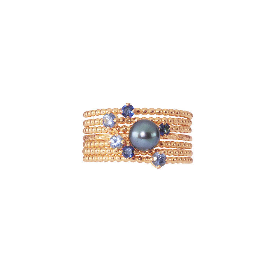 Midnight Stacking Set in rose gold, combining 3 Forget-Me-Not Blue sapphire rings and 3 Royal Blue sapphire rings together with a Pirate's Black Pearl ring.