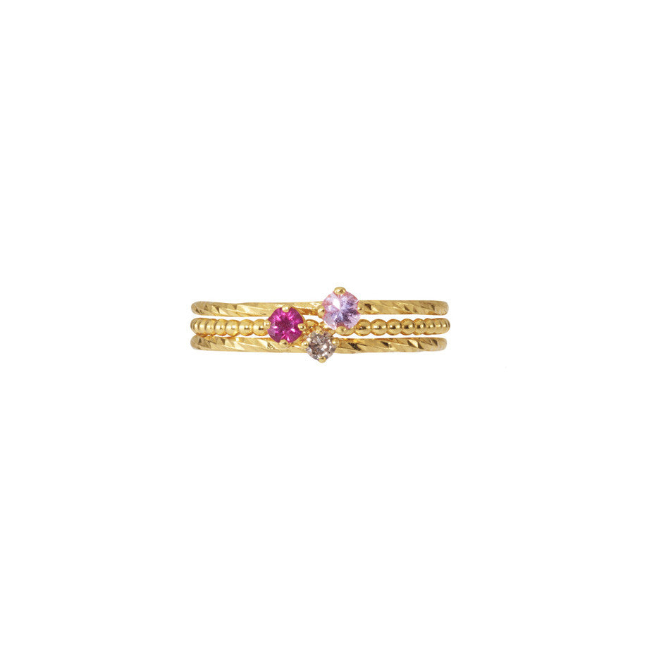 Valentine Stacking Trio in gold, featuring the Pretty in Pink Sapphire, Rose Red Ruby and Champagne Diamond rings.